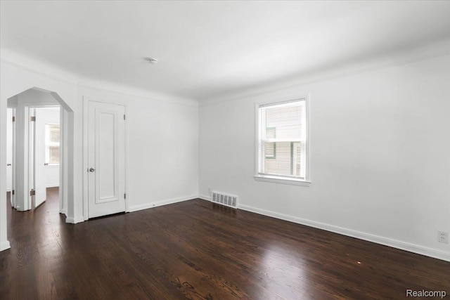 14535 Russell Ave, Allen Park, MI 48101 - unfurnished room with arched walkways and dark wood-style flooring