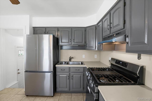 14535 Russell Ave, Allen Park, MI 48101 - kitchen featuring stainless steel appliances, gray cabinets, under cabinet range hood, light tile patterned floors, and light countertops