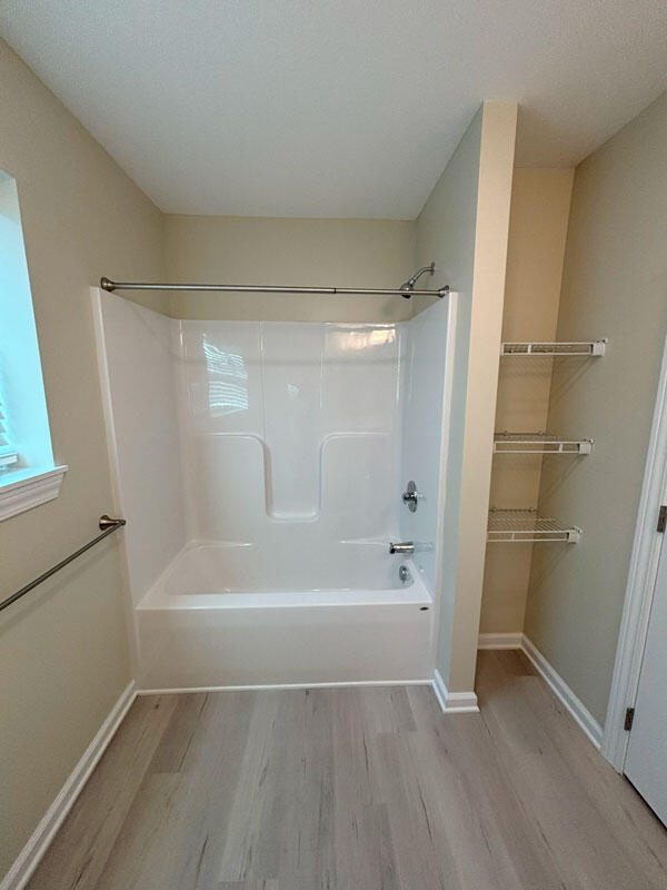 436 Martin Luther King Jr St SE, Grand Rapids, MI 49507 - full bathroom with wood finished floors and shower / tub combination