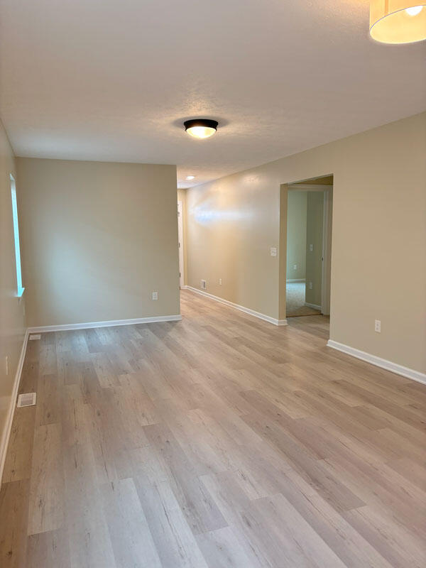 436 Martin Luther King Jr St SE, Grand Rapids, MI 49507 - spare room with light wood-style flooring and a textured ceiling