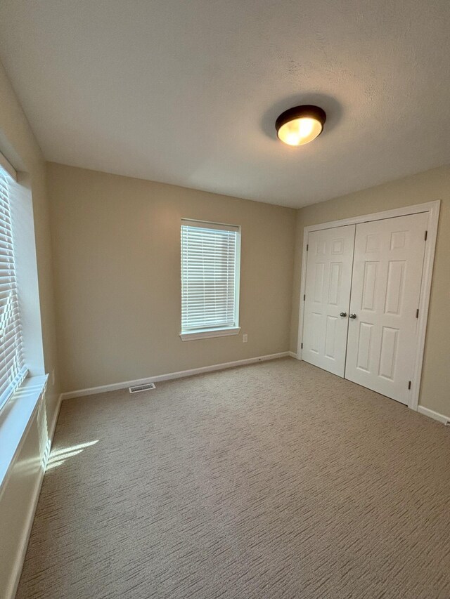 436 Martin Luther King Jr St SE, Grand Rapids, MI 49507 - unfurnished bedroom with a closet and carpet flooring