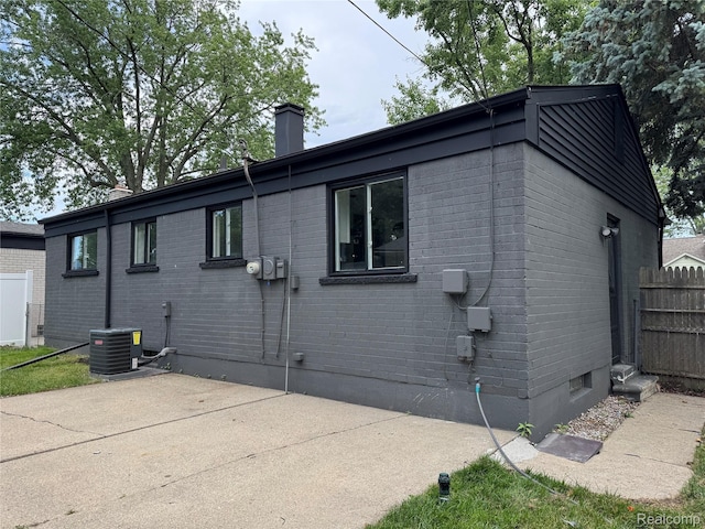22909 Garfield St, Saint Clair Shores, MI 48082 - view of home's exterior featuring a chimney, a patio, and brick siding