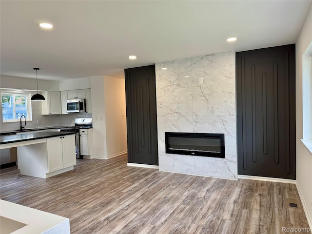 22909 Garfield St, Saint Clair Shores, MI 48082 - kitchen featuring stainless steel appliances, light wood-type flooring, open floor plan, white cabinets, and recessed lighting