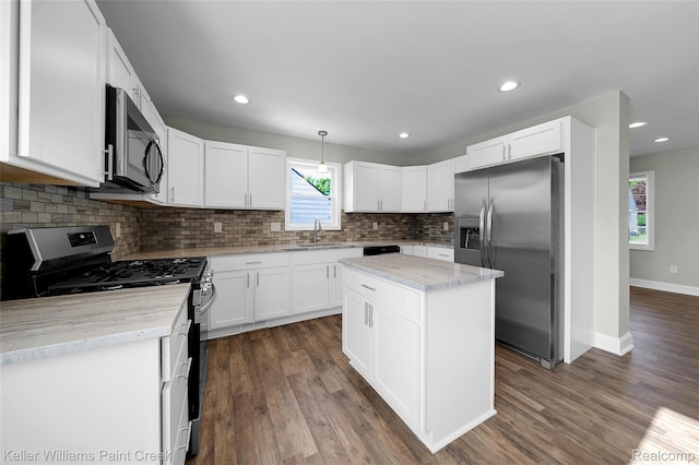 23858 Vassar Ave, Hazel Park, MI 48030 - kitchen featuring appliances with stainless steel finishes, tasteful backsplash, white cabinets, dark wood-type flooring, and recessed lighting