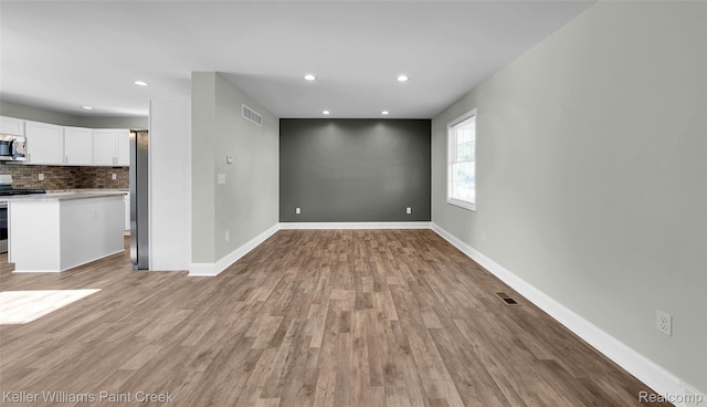 23858 Vassar Ave, Hazel Park, MI 48030 - unfurnished living room featuring light wood finished floors and recessed lighting