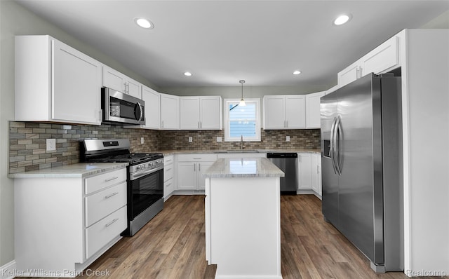 23858 Vassar Ave, Hazel Park, MI 48030 - kitchen featuring stainless steel appliances, a kitchen island, decorative backsplash, wood finished floors, and recessed lighting