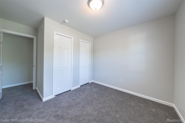 23858 Vassar Ave, Hazel Park, MI 48030 - unfurnished bedroom with dark carpet and two closets