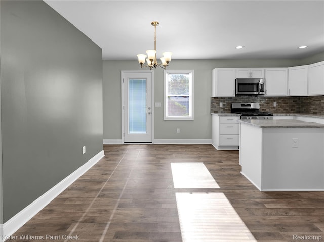23858 Vassar Ave, Hazel Park, MI 48030 - kitchen with appliances with stainless steel finishes, a chandelier, white cabinets, tasteful backsplash, and hanging light fixtures