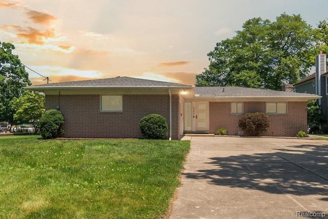 7262 Hatchery Rd, Waterford, MI 48327 - view of front of home featuring brick siding, a front lawn, and concrete driveway