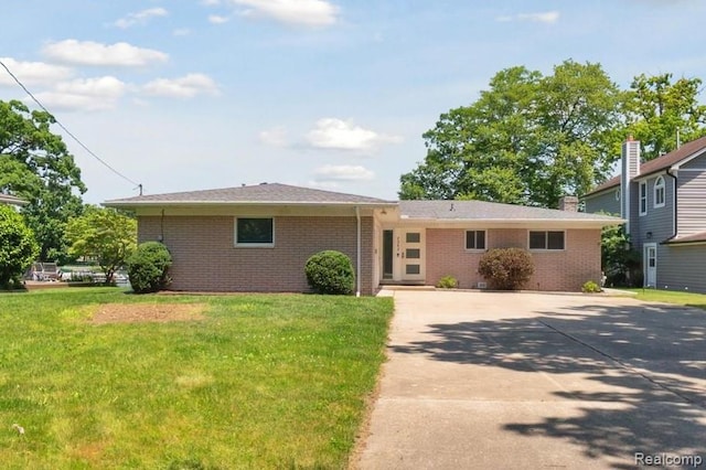 7262 Hatchery Rd, Waterford, MI 48327 - ranch-style home with driveway, brick siding, and a front lawn