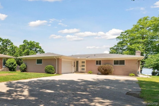 7262 Hatchery Rd, Waterford, MI 48327 - single story home with a garage, concrete driveway, brick siding, a chimney, and a front lawn