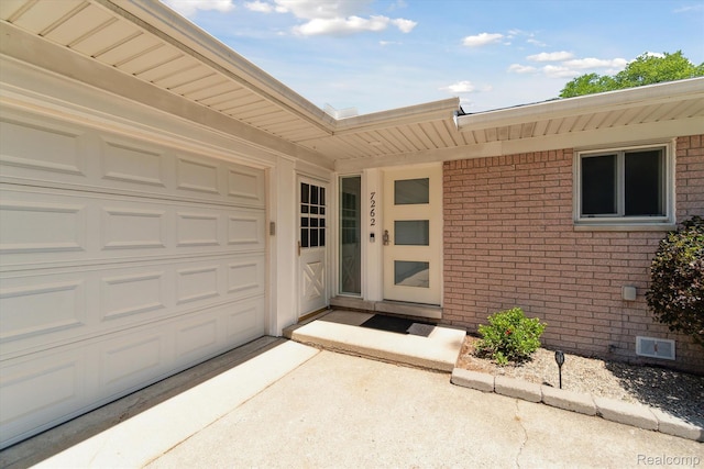 7262 Hatchery Rd, Waterford, MI 48327 - doorway to property featuring brick siding, driveway, and an attached garage