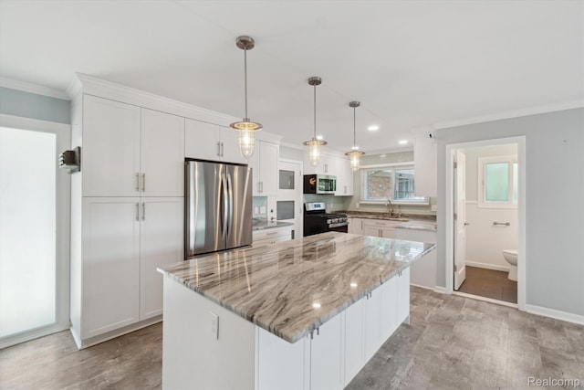 7262 Hatchery Rd, Waterford, MI 48327 - kitchen with appliances with stainless steel finishes, ornamental molding, white cabinets, light wood-type flooring, and a center island