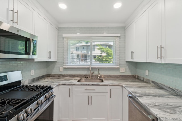 7262 Hatchery Rd, Waterford, MI 48327 - kitchen with stainless steel appliances, white cabinets, backsplash, and crown molding