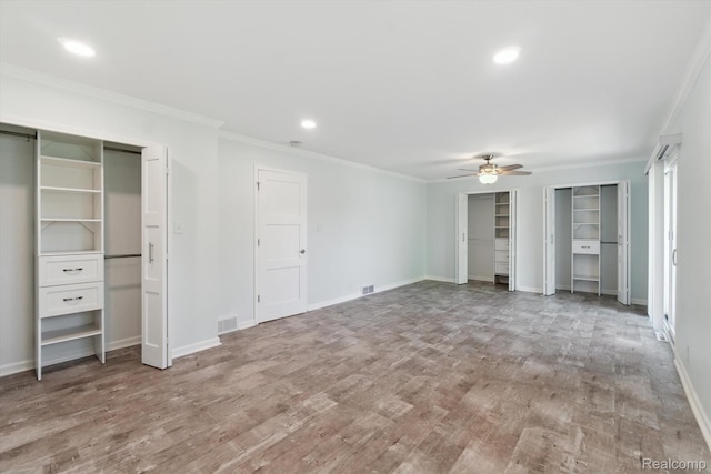 7262 Hatchery Rd, Waterford, MI 48327 - unfurnished bedroom featuring multiple closets, crown molding, wood finished floors, recessed lighting, and ceiling fan