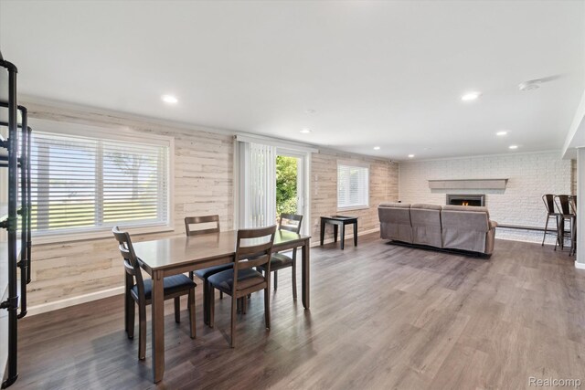 7262 Hatchery Rd, Waterford, MI 48327 - dining room with a fireplace, dark wood finished floors, recessed lighting, and crown molding