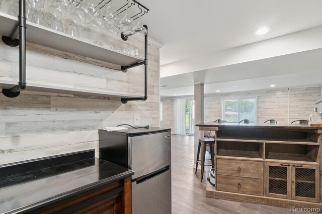7262 Hatchery Rd, Waterford, MI 48327 - kitchen with wood finished floors, freestanding refrigerator, decorative columns, and recessed lighting