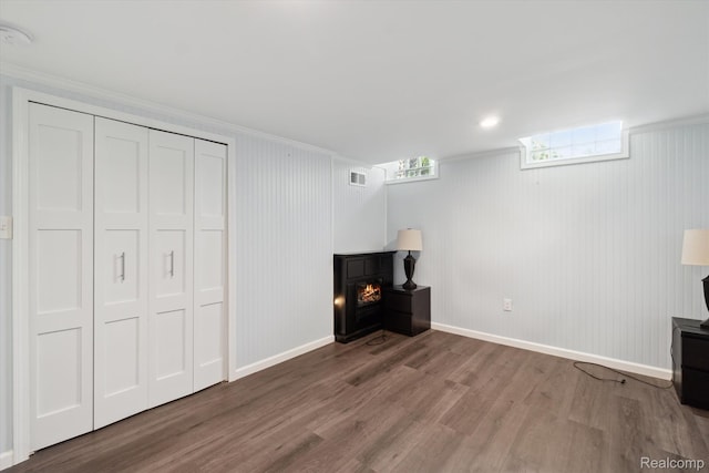 7262 Hatchery Rd, Waterford, MI 48327 - unfurnished living room with wood finished floors, crown molding, and a lit fireplace