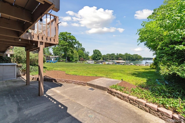 7262 Hatchery Rd, Waterford, MI 48327 - view of green lawn with a patio area and a water view