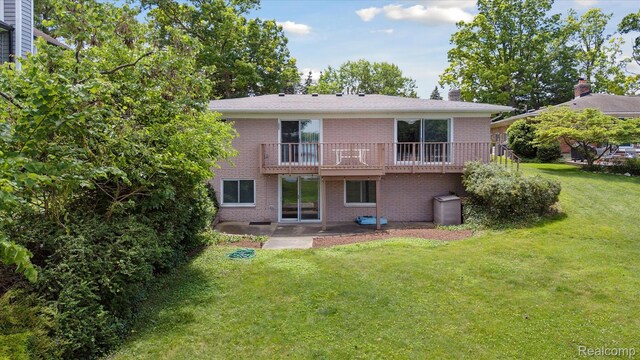 7262 Hatchery Rd, Waterford, MI 48327 - back of house featuring brick siding, a yard, a chimney, a deck, and a patio area