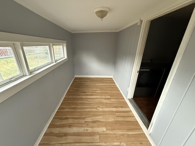 1414 Beard St, Port Huron, MI 48060 - spare room with light wood-type flooring, vaulted ceiling, and ornamental molding
