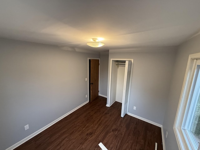 1414 Beard St, Port Huron, MI 48060 - unfurnished bedroom featuring dark wood-type flooring and a closet