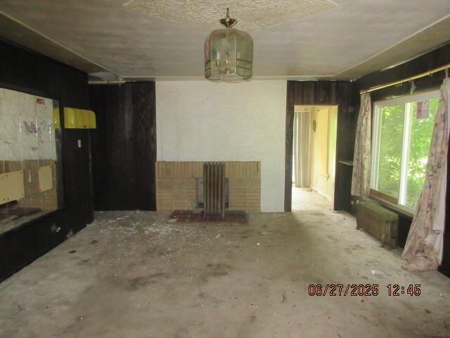 84 Somerset Ave, Battle Creek, MI 49037 - spare room with radiator heating unit and a chandelier