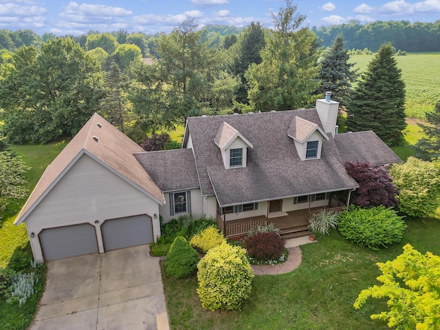 13972 S 5th St, Schoolcraft, MI 49087 - cape cod home with driveway, a chimney, an attached garage, covered porch, and a front lawn