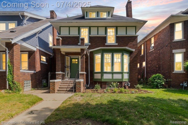 3801 Vicksburg St, Detroit, MI 48206 - view of front facade with a chimney, a front yard, and brick siding
