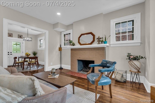3801 Vicksburg St, Detroit, MI 48206 - living area featuring wood finished floors, a chandelier, a brick fireplace, and recessed lighting