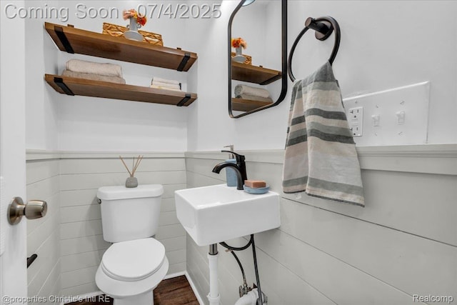 3801 Vicksburg St, Detroit, MI 48206 - half bathroom featuring a wainscoted wall, tile walls, and wood finished floors