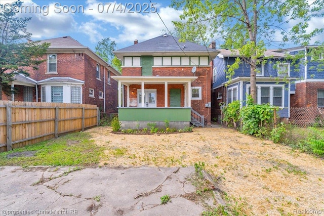 3801 Vicksburg St, Detroit, MI 48206 - rear view of house featuring brick siding, covered porch, and a chimney