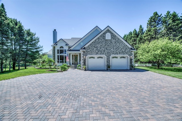 24559 S Klingville Rd, Chassell, MI 49916 - view of front of property with driveway, a chimney, a front yard, and an attached garage
