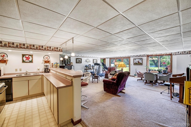 24559 S Klingville Rd, Chassell, MI 49916 - kitchen with open floor plan, cream cabinetry, light carpet, white microwave, and dishwasher
