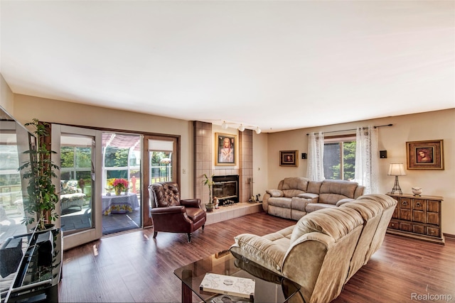 24559 S Klingville Rd, Chassell, MI 49916 - living area featuring wood finished floors, a tile fireplace, and rail lighting