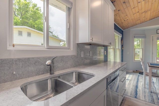22770 Oak St, Pierson, MI 49339 - kitchen featuring dishwasher, tasteful backsplash, lofted ceiling, white cabinets, and light stone countertops