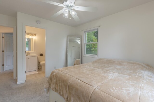 22770 Oak St, Pierson, MI 49339 - bedroom featuring light colored carpet, ensuite bath, and a ceiling fan