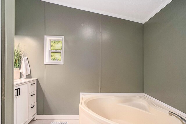 713 Maple Rd, Ionia, MI 48846 - bathroom with a garden tub, vanity, and ornamental molding