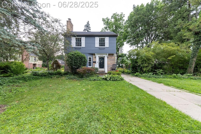 31718 W Chicago St, Canton, MI 48150 - colonial inspired home featuring a chimney, a front yard, and stone siding