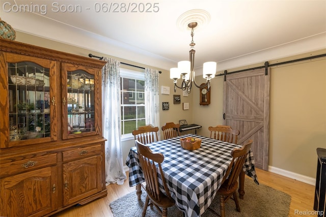 31718 W Chicago St, Canton, MI 48150 - dining space with a chandelier, light wood finished floors, and a barn door