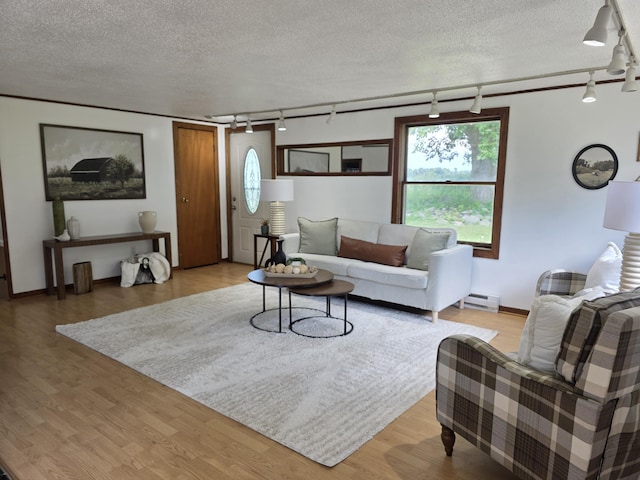 1236 Klink Rd, Tekonsha, MI 49092 - living room with rail lighting, a baseboard heating unit, a textured ceiling, and wood finished floors