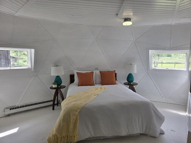 1236 Klink Rd, Tekonsha, MI 49092 - bedroom featuring a baseboard heating unit, concrete floors, and a decorative wall