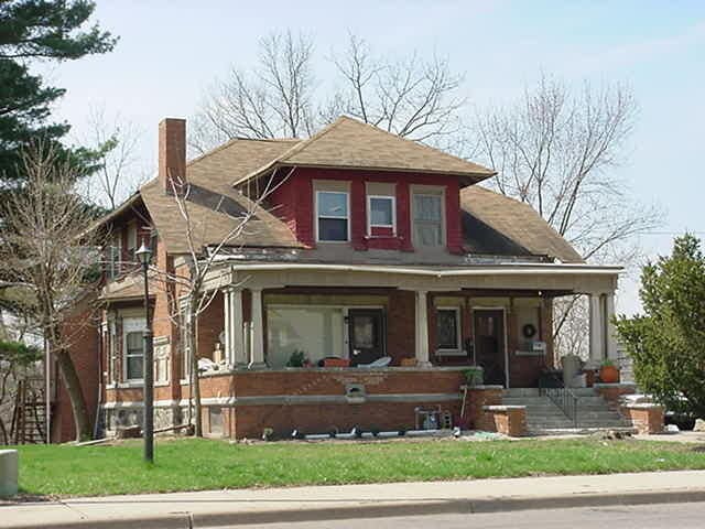 619 W Michigan Ave, Battle Creek, MI 49037 - view of front facade with a chimney, covered porch, and a front yard
