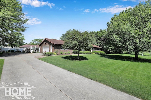 2367 Meadowdown Dr, Owosso, MI 48867 - ranch-style home with driveway, a front yard, an attached garage, and brick siding