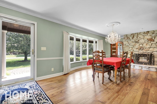 2367 Meadowdown Dr, Owosso, MI 48867 - dining room featuring a chandelier, ornamental molding, and light wood-style floors