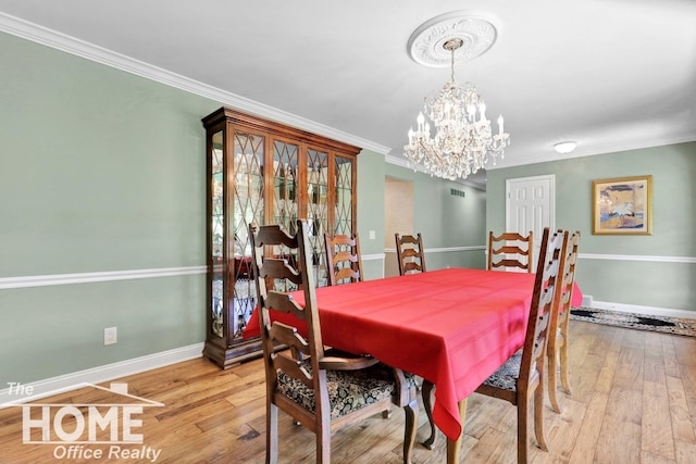 2367 Meadowdown Dr, Owosso, MI 48867 - dining room featuring crown molding, a chandelier, and wood-type flooring