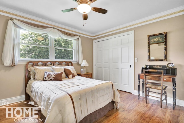 2367 Meadowdown Dr, Owosso, MI 48867 - bedroom featuring wood finished floors, ornamental molding, a closet, and ceiling fan