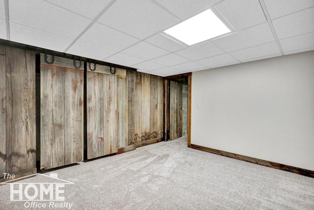 2367 Meadowdown Dr, Owosso, MI 48867 - finished basement with wood walls, a drop ceiling, and carpet floors