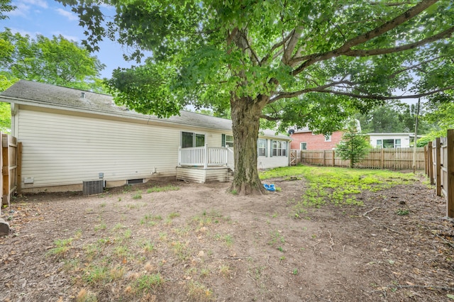 733 N Main St, Evart, MI 49631 - back of house featuring a fenced backyard, a wooden deck, and crawl space