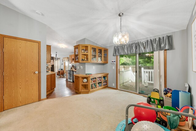 733 N Main St, Evart, MI 49631 - recreation room featuring a chandelier, carpet flooring, and lofted ceiling